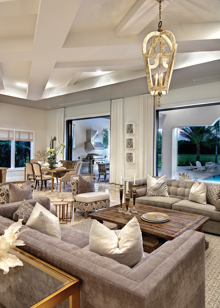 Inspiration for a large mediterranean open concept family room in Miami with beige walls, no fireplace and carpet.