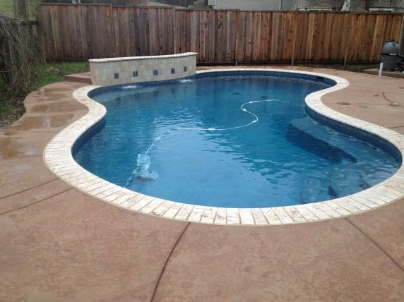 Example of a large backyard stone and custom-shaped natural hot tub design in San Francisco
