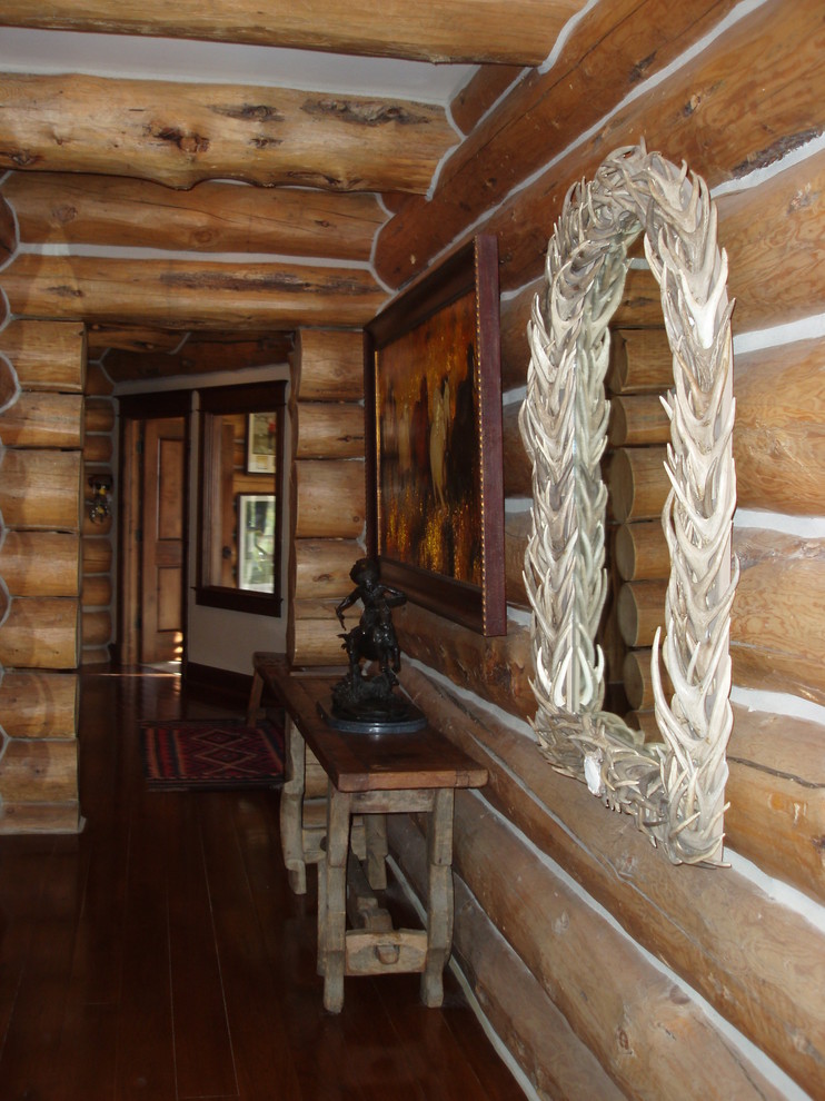 Hallway - rustic dark wood floor hallway idea with brown walls