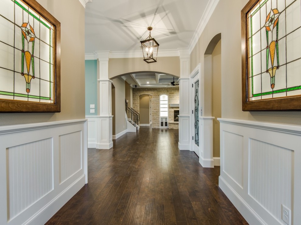 Inspiration for a mid-sized transitional medium tone wood floor entryway remodel in Dallas with beige walls and a brown front door
