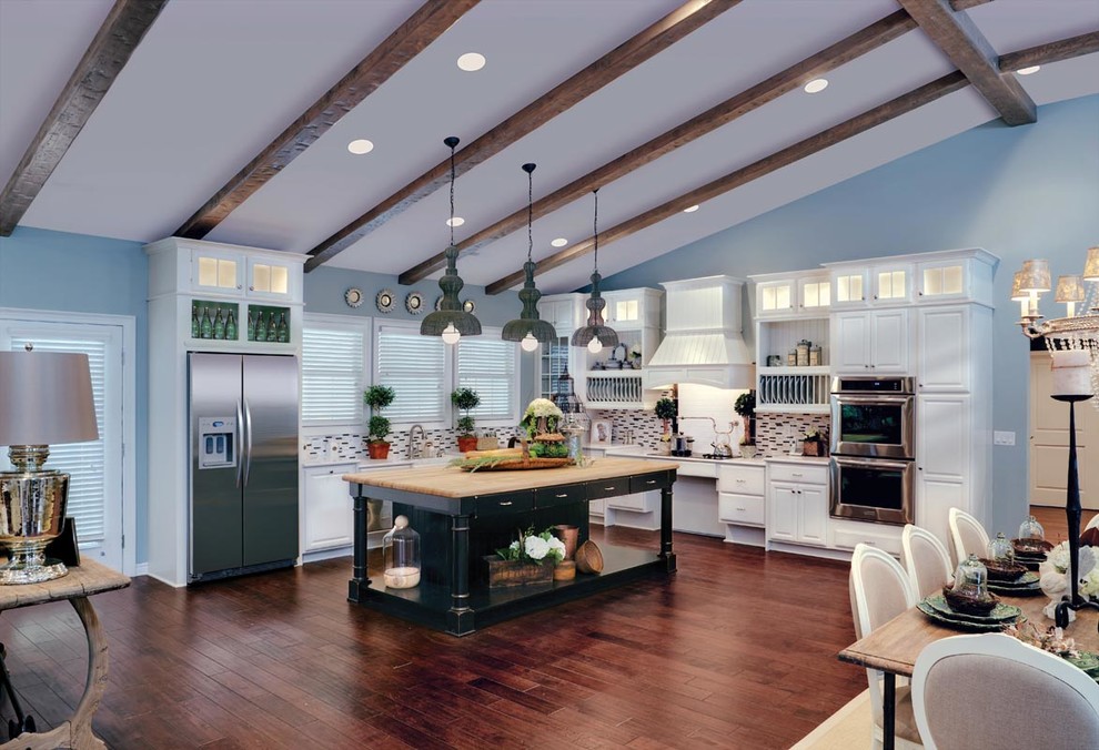 Large transitional l-shaped eat-in kitchen in Detroit with raised-panel cabinets, white cabinets, multi-coloured splashback, stainless steel appliances, dark hardwood floors and with island.