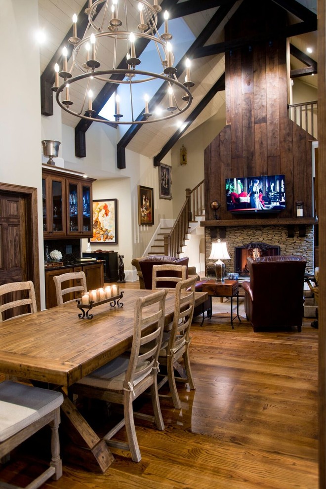 Design ideas for a mid-sized traditional open plan dining in Atlanta with white walls, medium hardwood floors, a standard fireplace and a stone fireplace surround.