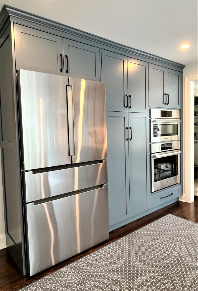 Transitional kitchen photo in New York with shaker cabinets, blue cabinets and stainless steel appliances