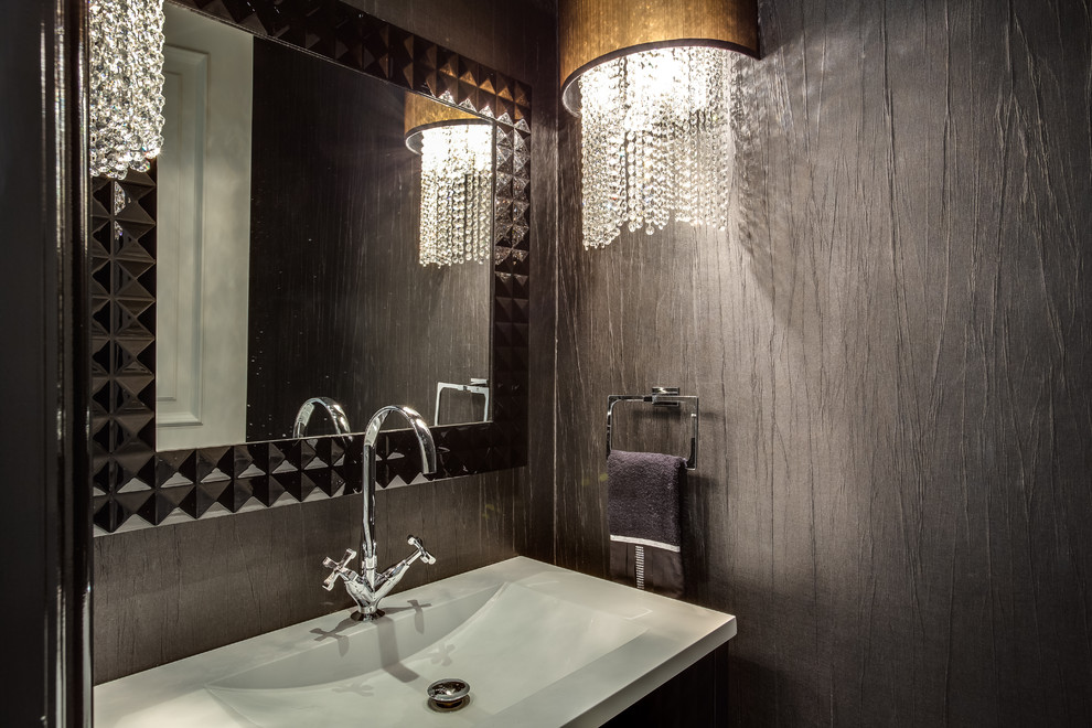 Small contemporary powder room in Toronto with an integrated sink, black tile, porcelain tile and black walls.