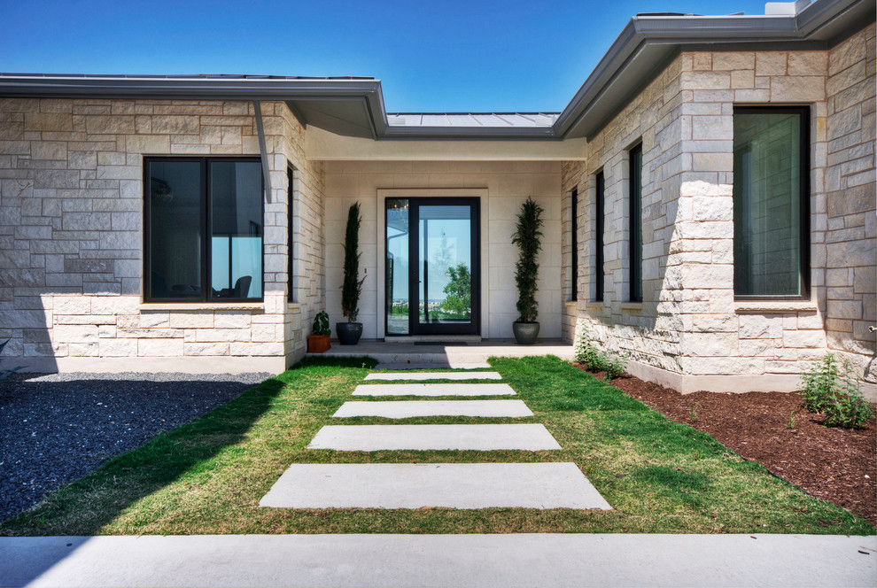 Design ideas for a contemporary entryway in Austin with a glass front door.
