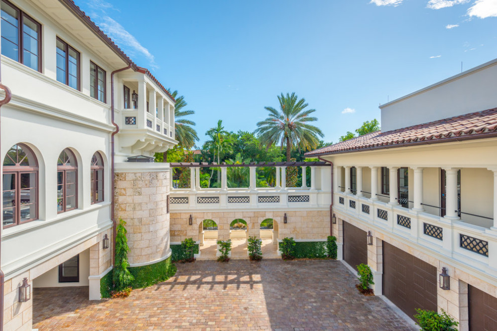 Photo of a large mediterranean attached four-car porte cochere in Other.