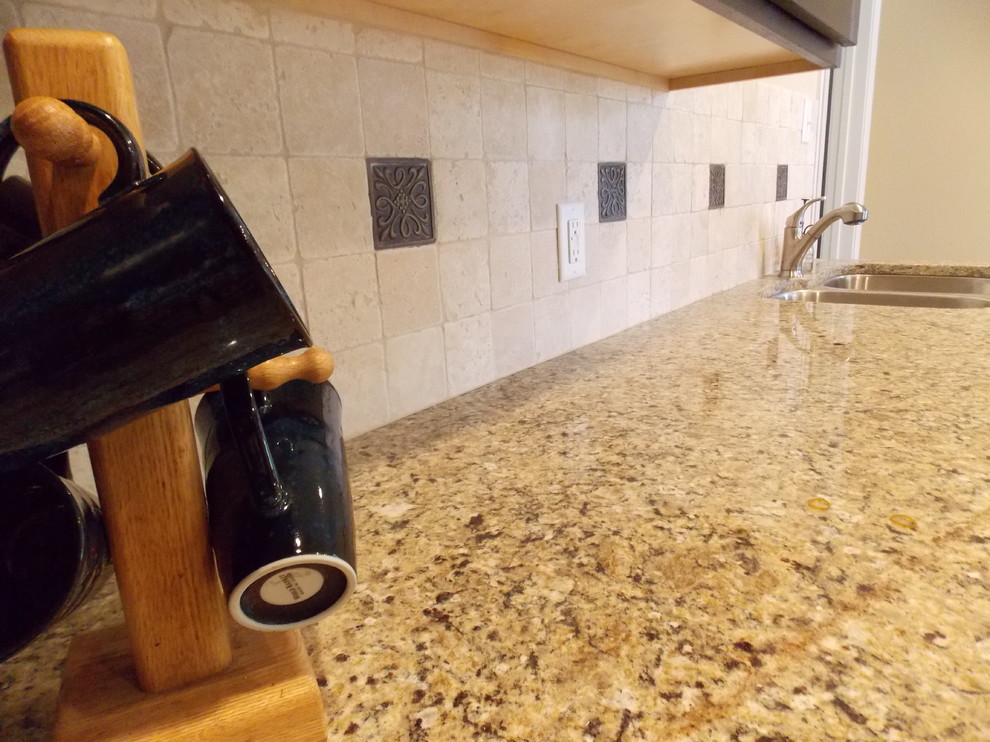 Example of a mid-sized galley ceramic tile open concept kitchen design in Austin with an undermount sink, flat-panel cabinets, dark wood cabinets, granite countertops, beige backsplash, stone tile backsplash and stainless steel appliances