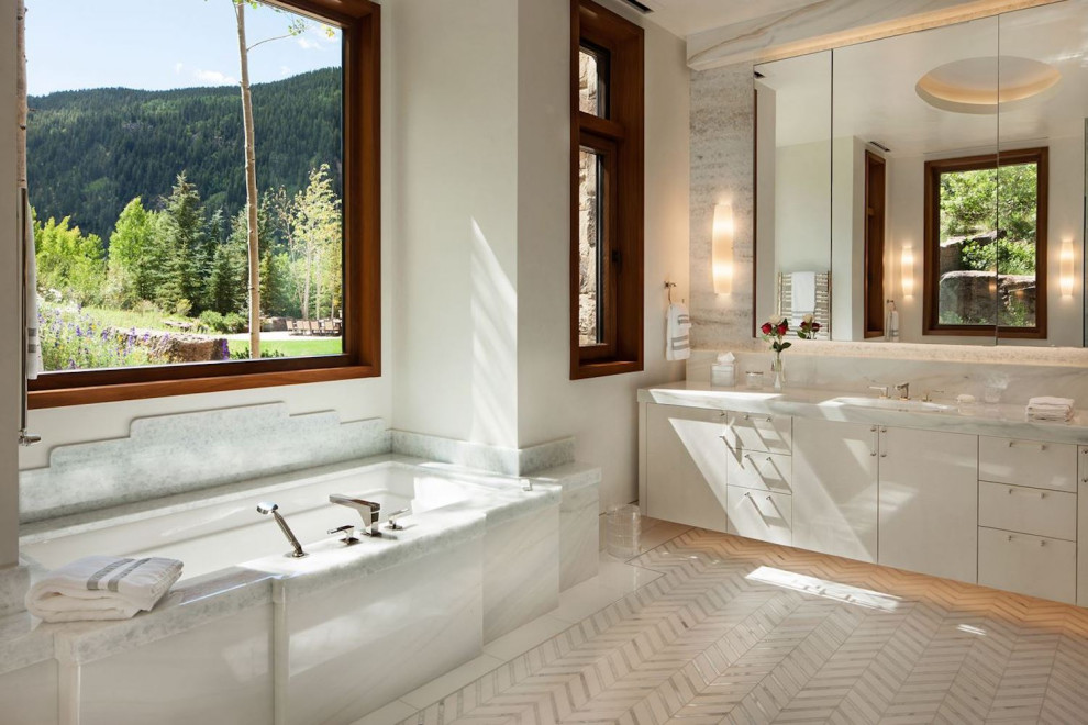 Inspiration for a large contemporary master bathroom in Denver with flat-panel cabinets, white cabinets, an alcove tub, multi-coloured tile, marble, beige walls, marble floors, a drop-in sink, marble benchtops, white floor, white benchtops, a single vanity and a built-in vanity.