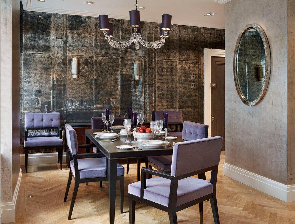 Design ideas for a mid-sized transitional open plan dining in London with light hardwood floors.