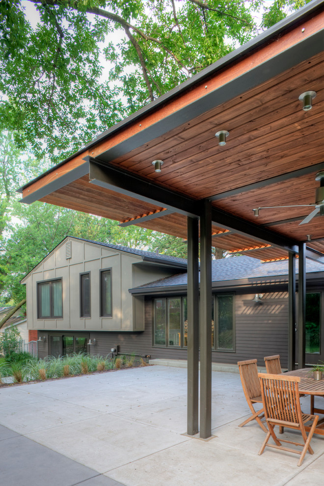 Design ideas for a contemporary backyard patio in Omaha with a pergola.