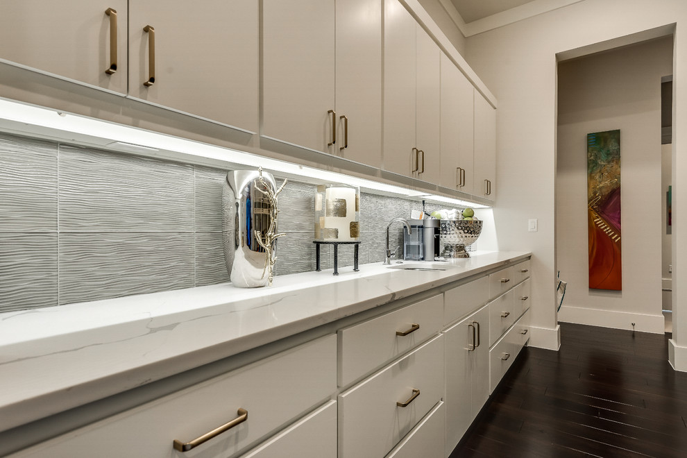Example of a large transitional galley kitchen pantry design in Dallas with flat-panel cabinets, white cabinets, quartz countertops and an island