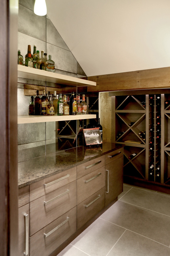 Photo of a mid-sized contemporary l-shaped seated home bar in Orange County with an undermount sink, flat-panel cabinets, brown cabinets, marble benchtops, multi-coloured splashback, slate floors and mirror splashback.
