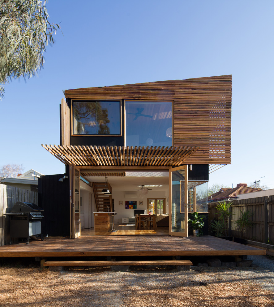 This is an example of a contemporary two-storey exterior in Melbourne with wood siding and a shed roof.