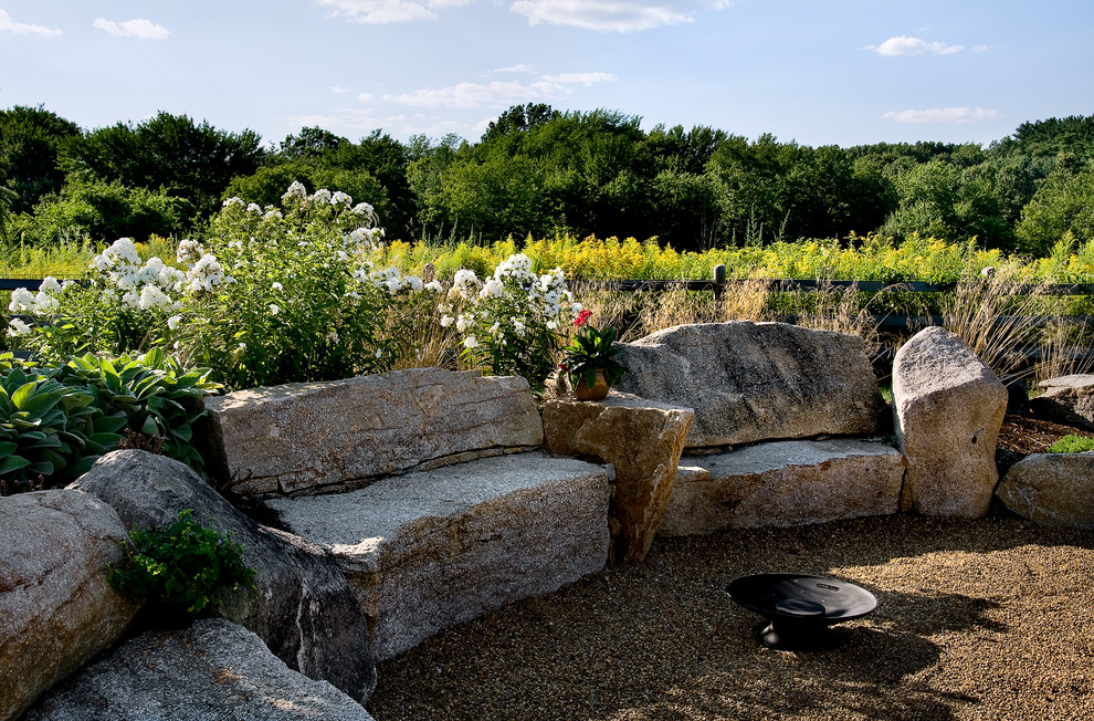 Inspiration for a country garden in Boston with a fire feature and gravel.