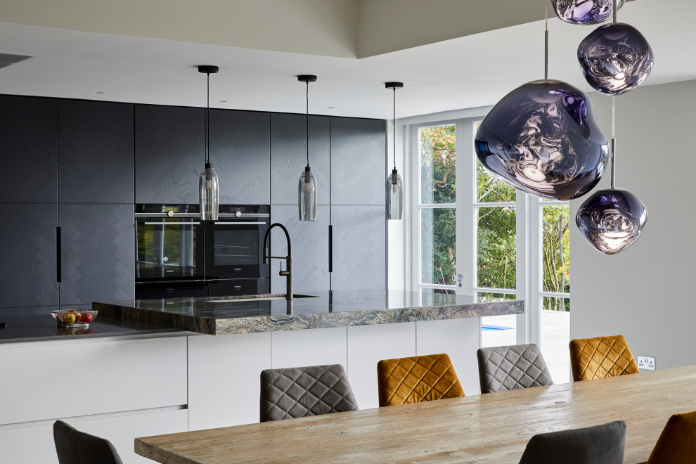 Photo of an expansive contemporary single-wall kitchen/diner in Kent with flat-panel cabinets, dark wood cabinets, multi-coloured splashback, stone slab splashback, stainless steel appliances, porcelain flooring, an island, grey floors and multicoloured worktops.