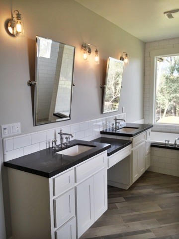 Photo of a transitional master bathroom in Sacramento with flat-panel cabinets, white cabinets, a drop-in tub, grey walls, medium hardwood floors, a drop-in sink and granite benchtops.
