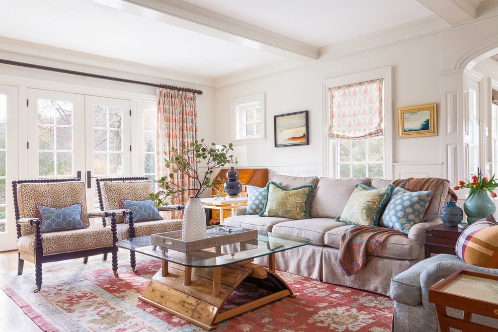 Inspiration for a large traditional open concept living room in Boston with white walls and light hardwood floors.