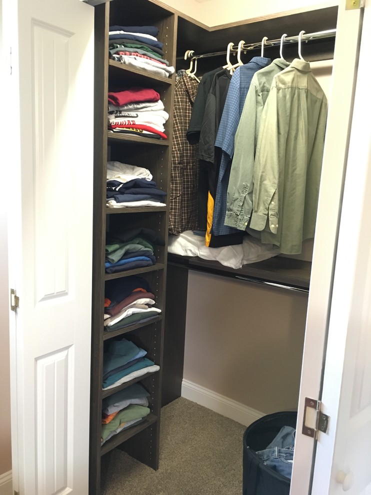 Inspiration for a small transitional gender-neutral carpeted reach-in closet remodel with flat-panel cabinets and dark wood cabinets