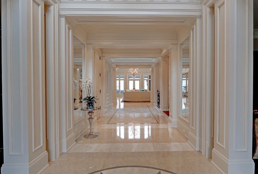 Photo of a large transitional hallway in Toronto with white walls, ceramic floors and beige floor.
