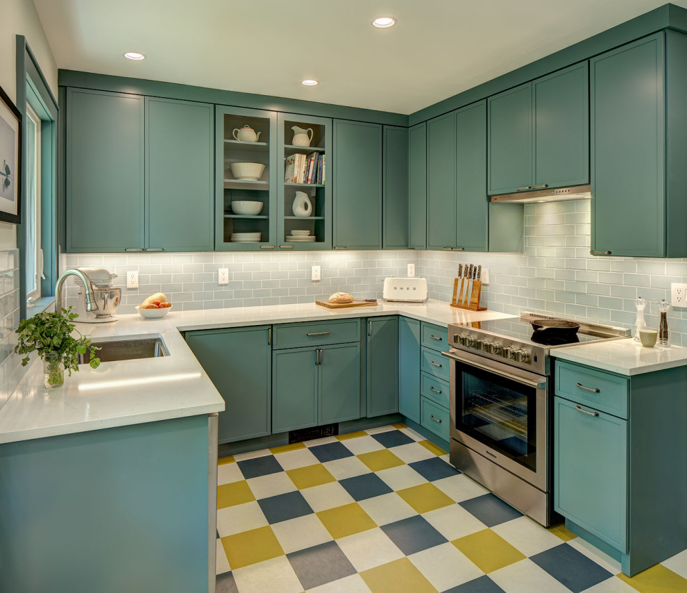 Small classic u-shaped enclosed kitchen in New York with a submerged sink, recessed-panel cabinets, blue cabinets, engineered stone countertops, blue splashback, ceramic splashback, stainless steel appliances, lino flooring, no island, multi-coloured floors and white worktops.