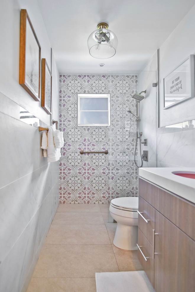 Small contemporary 3/4 bathroom in Miami with flat-panel cabinets, medium wood cabinets, a curbless shower, a two-piece toilet, pink tile, porcelain tile, pink walls, porcelain floors, an undermount sink, marble benchtops, beige floor, an open shower and white benchtops.