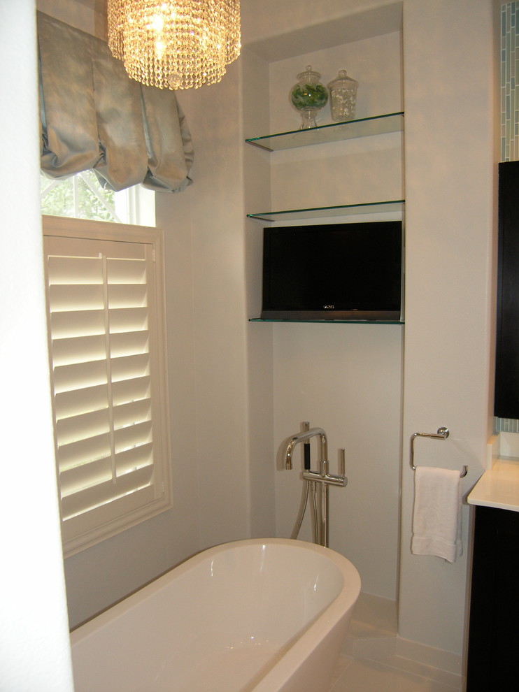 This is an example of a small contemporary master bathroom in Tampa with flat-panel cabinets, dark wood cabinets, a freestanding tub, an alcove shower, a one-piece toilet, beige tile, blue tile, gray tile, multi-coloured tile, white tile, matchstick tile, beige walls, travertine floors, an undermount sink and engineered quartz benchtops.