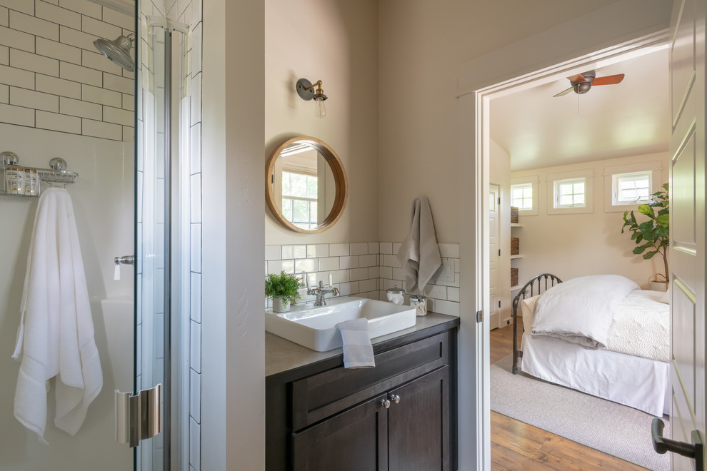 Small transitional 3/4 bathroom in Other with shaker cabinets, dark wood cabinets, an alcove shower, white tile, subway tile, beige walls, medium hardwood floors, a vessel sink, laminate benchtops, brown floor, a hinged shower door and beige benchtops.