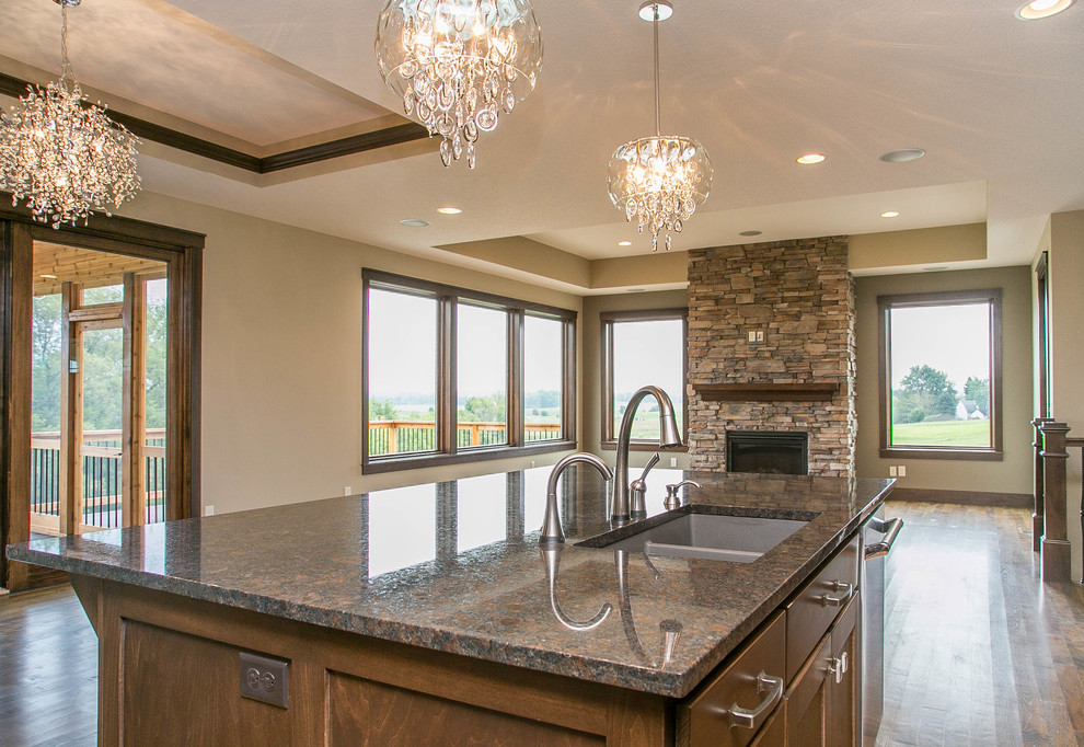 Inspiration for a transitional l-shaped dark wood floor open concept kitchen remodel in Minneapolis with a drop-in sink, shaker cabinets, dark wood cabinets, granite countertops, multicolored backsplash, ceramic backsplash, stainless steel appliances and an island