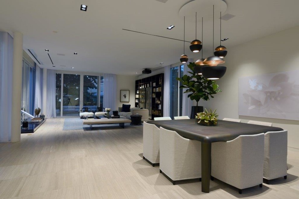 This is an example of a large contemporary open plan dining in Miami with grey walls, light hardwood floors, no fireplace and brown floor.