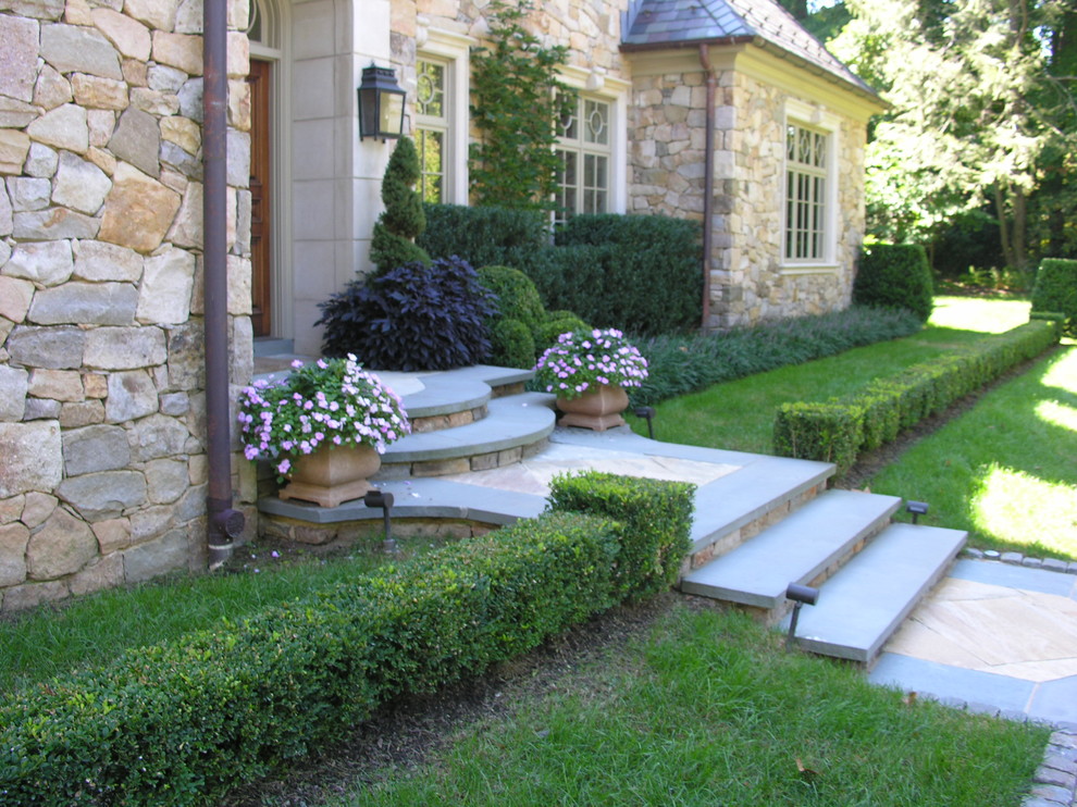 Photo of a mid-sized traditional full sun front yard stone garden path in Philadelphia for summer.