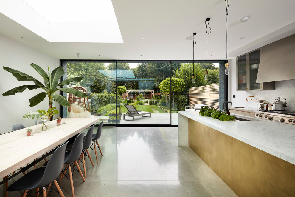 Inspiration for a contemporary open plan kitchen in London with marble benchtops, white splashback, concrete floors and with island.