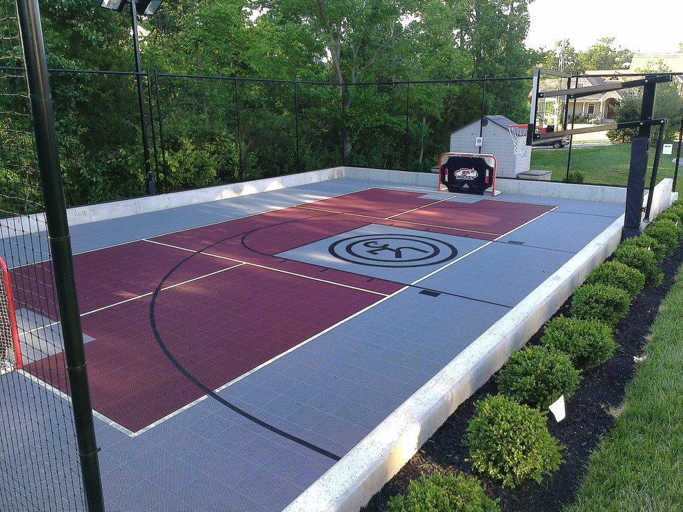 Photo of a large traditional backyard partial sun outdoor sport court for spring in St Louis with a retaining wall.