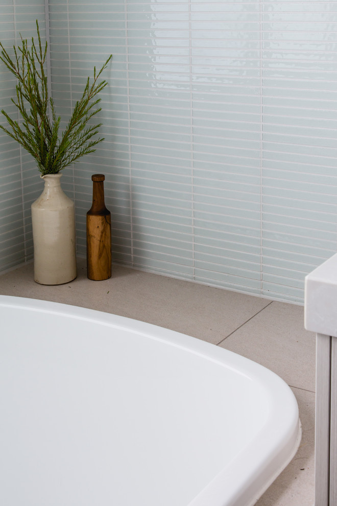 Photo of a mid-sized modern master bathroom in Melbourne with grey cabinets, blue tile, glass tile and white walls.