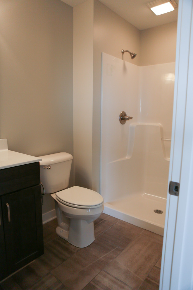 Inspiration for a mid-sized transitional master beige tile and porcelain tile porcelain tile home design remodel in Chicago with shaker cabinets, gray cabinets, a two-piece toilet, gray walls, a drop-in sink and marble countertops