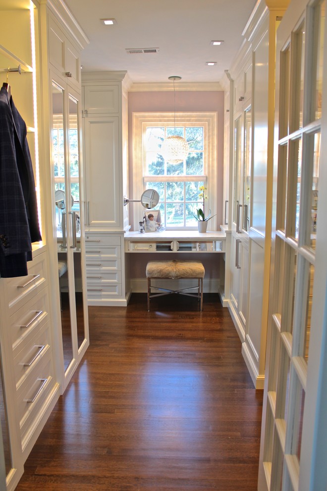 Walk-in closet - large contemporary gender-neutral dark wood floor walk-in closet idea in New York with recessed-panel cabinets and white cabinets