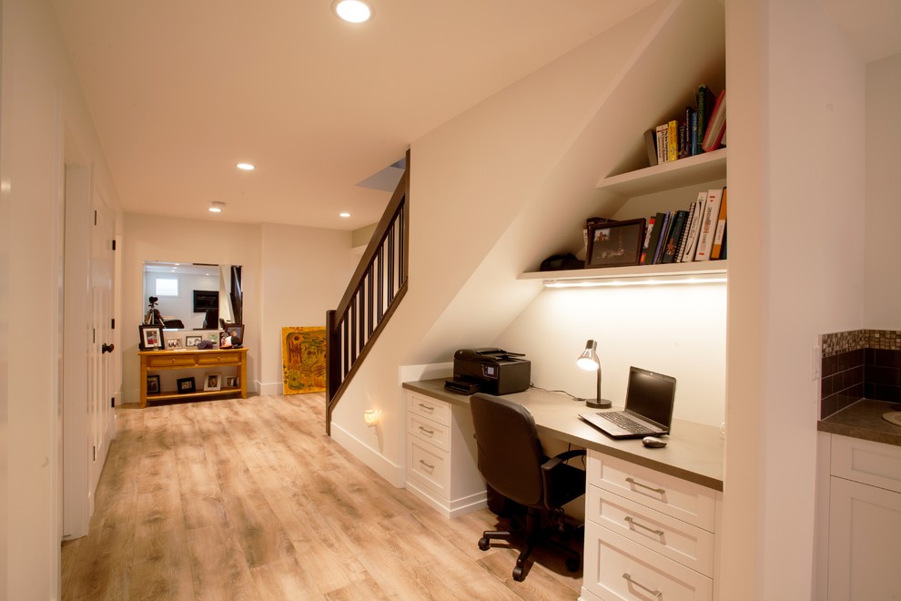 Inspiration for a mid-sized arts and crafts look-out basement in Calgary with beige walls and beige floor.