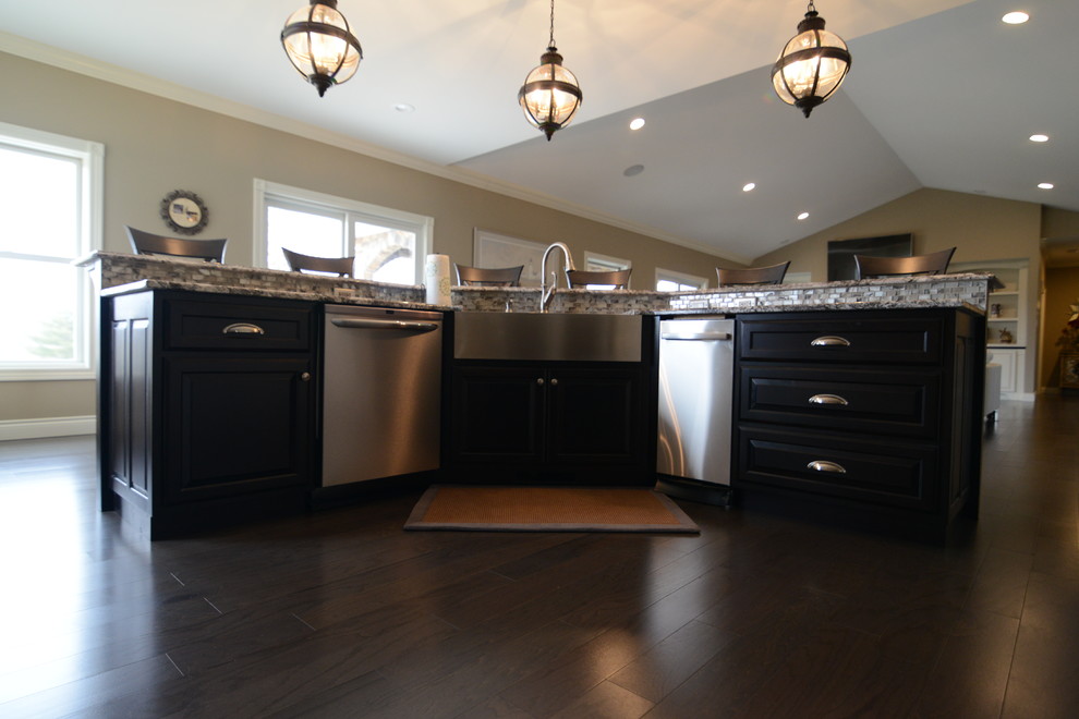 Inspiration for a huge transitional l-shaped medium tone wood floor eat-in kitchen remodel in Chicago with a farmhouse sink, raised-panel cabinets, white cabinets, granite countertops, beige backsplash, stone tile backsplash, stainless steel appliances and an island