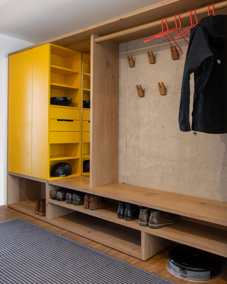 This is an example of a contemporary mudroom in Munich with medium hardwood floors and brown floor.