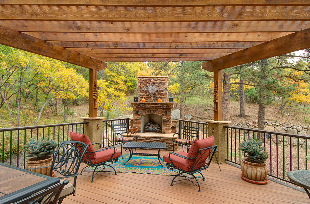 Inspiration for a large rustic backyard deck remodel in Denver with a fire pit and a pergola