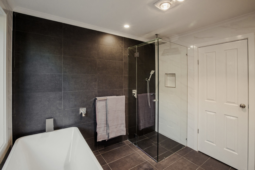 Mid-sized contemporary kids bathroom in Adelaide with flat-panel cabinets, white cabinets, a freestanding tub, a corner shower, a two-piece toilet, white tile, ceramic tile, white walls, ceramic floors, a vessel sink, wood benchtops, grey floor and a hinged shower door.