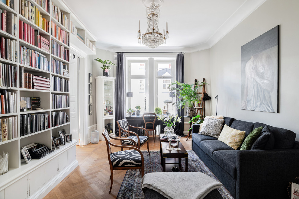 Photo of a mid-sized scandinavian formal enclosed living room in Stockholm with white walls, light hardwood floors, no tv and beige floor.