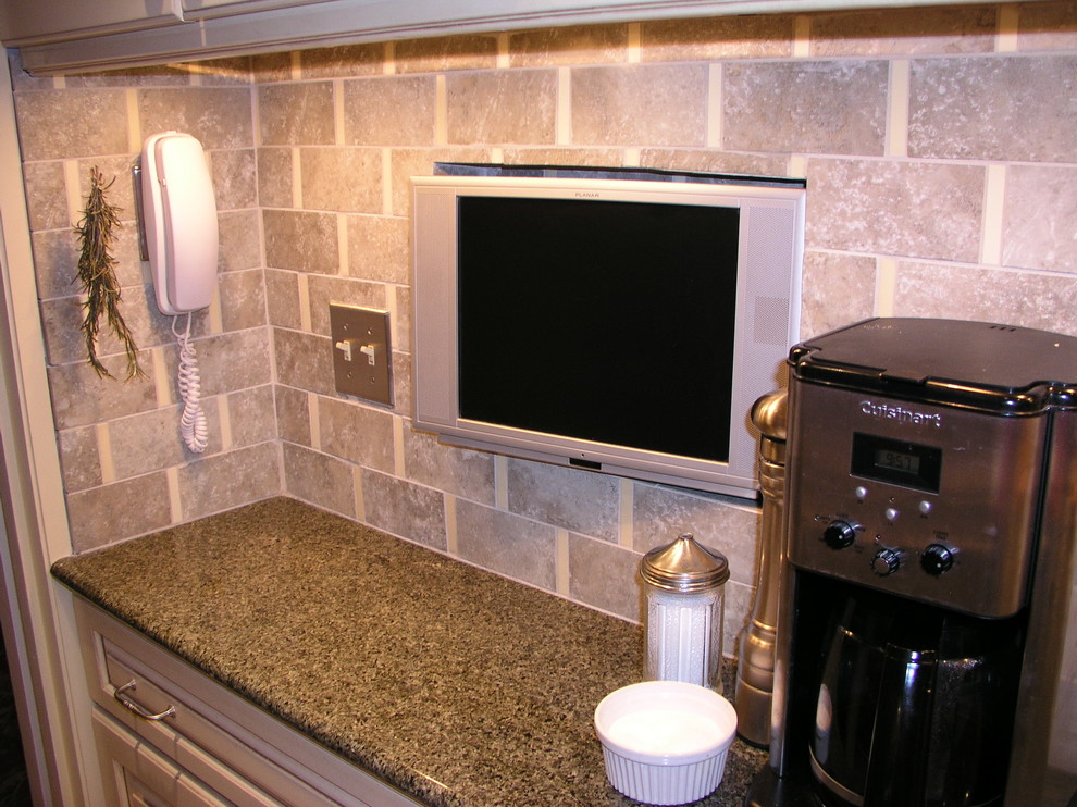 Small transitional galley ceramic tile enclosed kitchen photo in New York with raised-panel cabinets, granite countertops, ceramic backsplash, stainless steel appliances and no island