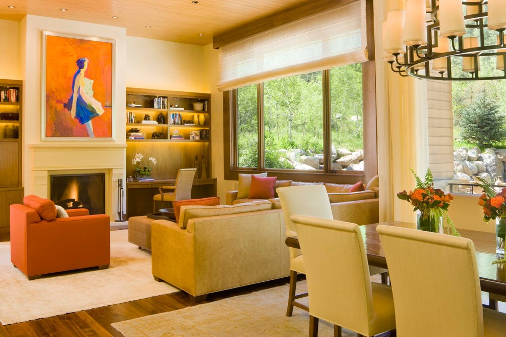 Eclectic living room in Denver with yellow walls and a standard fireplace.