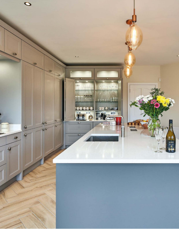 Eclectic kitchen in Other with a drop-in sink, quartzite benchtops, white splashback, slate splashback, stainless steel appliances, ceramic floors, brown floor, white benchtop and recessed.