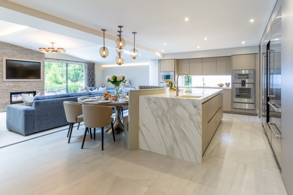 Inspiration for a large contemporary l-shaped open plan kitchen in Cheshire with flat-panel cabinets, grey cabinets, tile countertops, an island and white worktops.