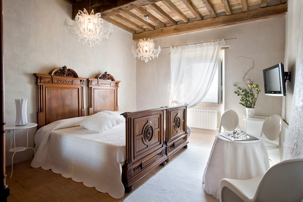 Photo of a large traditional guest bedroom in Florence with white walls and no fireplace.