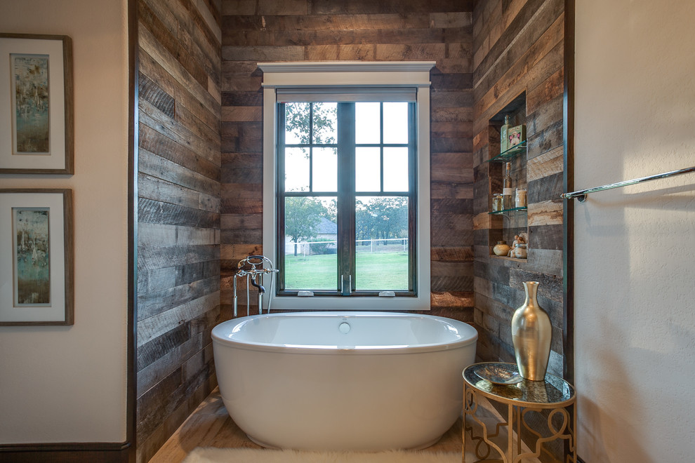 Inspiration for a large country master bathroom in Dallas with flat-panel cabinets, dark wood cabinets, a freestanding tub, beige walls, a vessel sink, medium hardwood floors and brown floor.