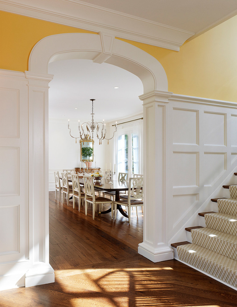 Inspiration for a traditional separate dining room in DC Metro with white walls and dark hardwood floors.