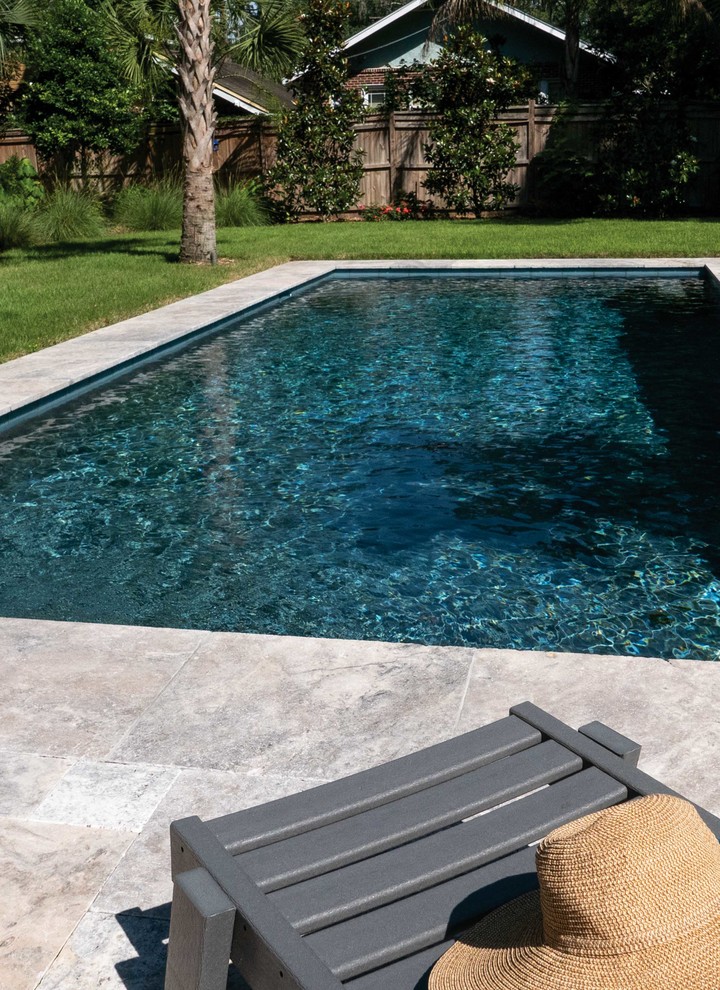 Photo of a mid-sized traditional backyard rectangular pool in Jacksonville with natural stone pavers.
