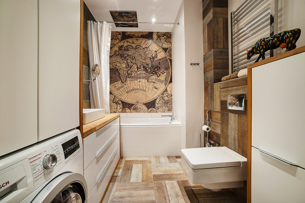 This is an example of a contemporary bathroom in Moscow with an alcove tub and a wall-mount toilet.